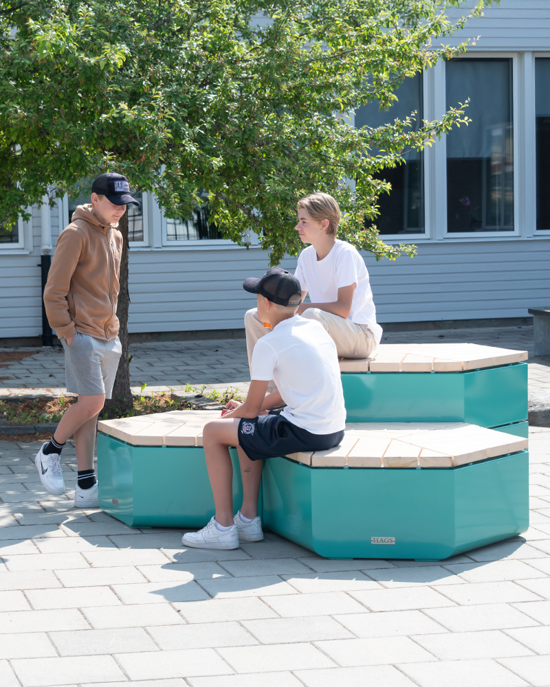 A group of boys sitting on a Rosenlund seating combination.